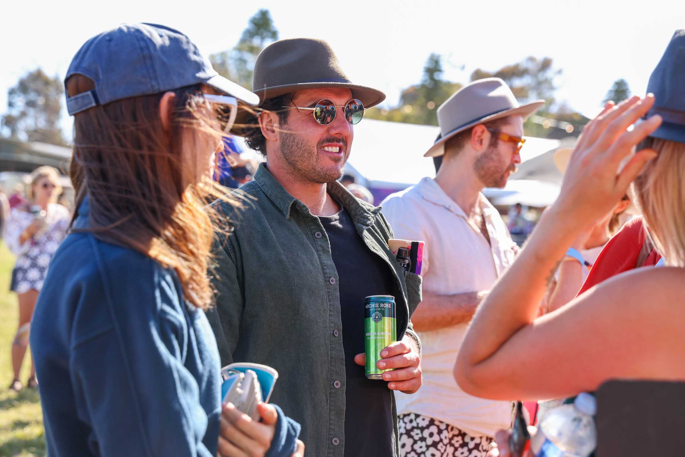 People in hats drinking in festival