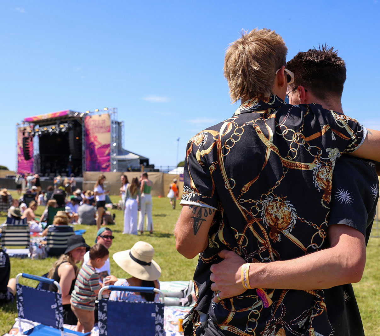 Two people watching stage
